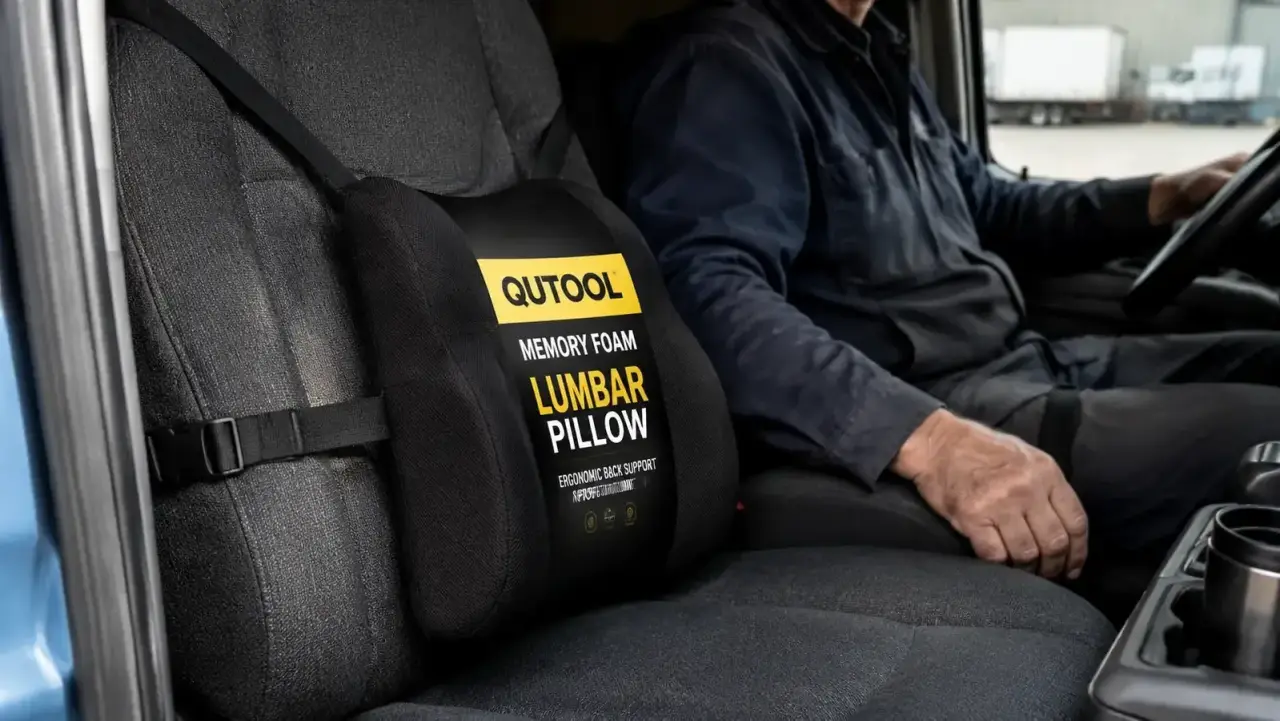 Close-up of QUTOOL lumbar support pillow strapped to a truck seat with dual adjustable straps visible